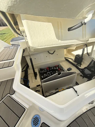 The Good Stuff Yacht Photos Pics 2023 Sea Ray SLX 310 OB boat storage compartment with open hatch, showcasing interior details.