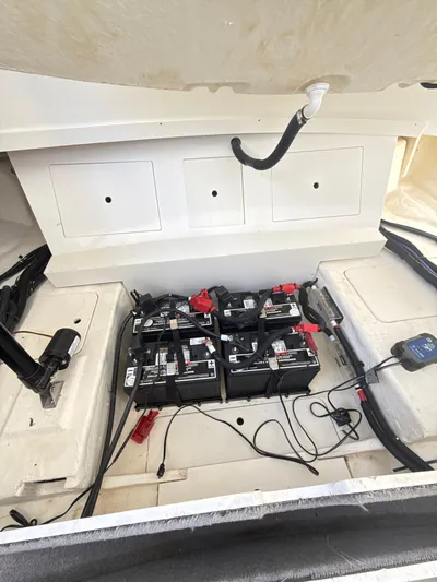 The Good Stuff Yacht Photos Pics 2023 Sea Ray SLX 310 OB boat battery compartment with multiple batteries and wiring.