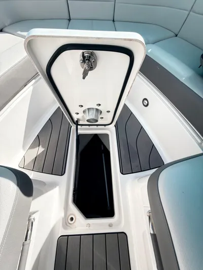 The Good Stuff Yacht Photos Pics 2023 Sea Ray SLX 310 OB storage compartment with open hatch, showcasing sleek interior design.