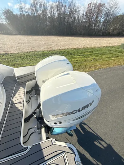 The Good Stuff Yacht Photos Pics 2023 Sea Ray SLX 310 OB with twin Mercury outboard engines on a sunny day.