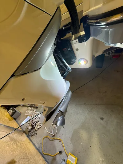 The Good Stuff Yacht Photos Pics 2023 Sea Ray SLX 310 OB boat engine detail in a garage setting.