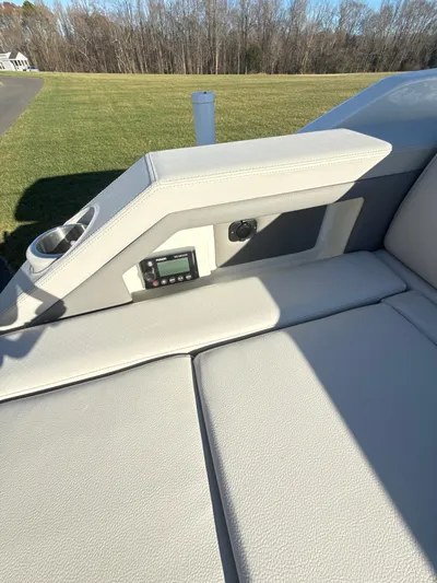 The Good Stuff Yacht Photos Pics 2023 Sea Ray SLX 310 OB boat interior with cushioned seating and control panel.