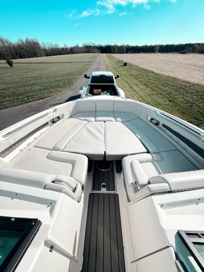The Good Stuff Yacht Photos Pics 2023 Sea Ray SLX 310 OB boat on trailer, parked on a scenic rural road.