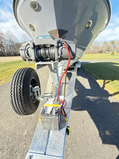 The Good Stuff Yacht Photos Pics 2023 Sea Ray SLX 310 OB boat trailer with winch and wheel on a sunny day.