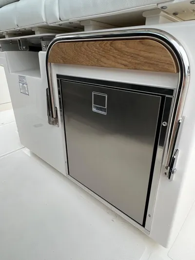  Yacht Photos Pics 2026 Tiara Yachts 34 LS interior with stainless steel appliance and cushioned seating.