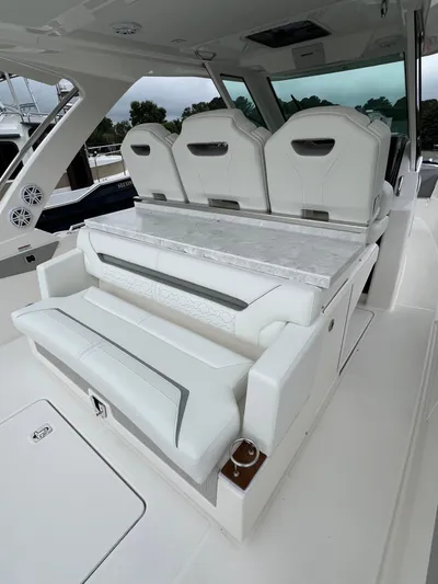  Yacht Photos Pics 2026 Tiara Yachts 34 LS interior with luxurious white seating and sleek design.