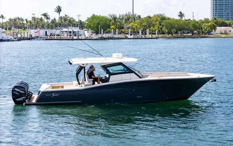  Yacht Photos Pics 2020 Scout 380 LXF boat cruising on a sunny day near a marina.