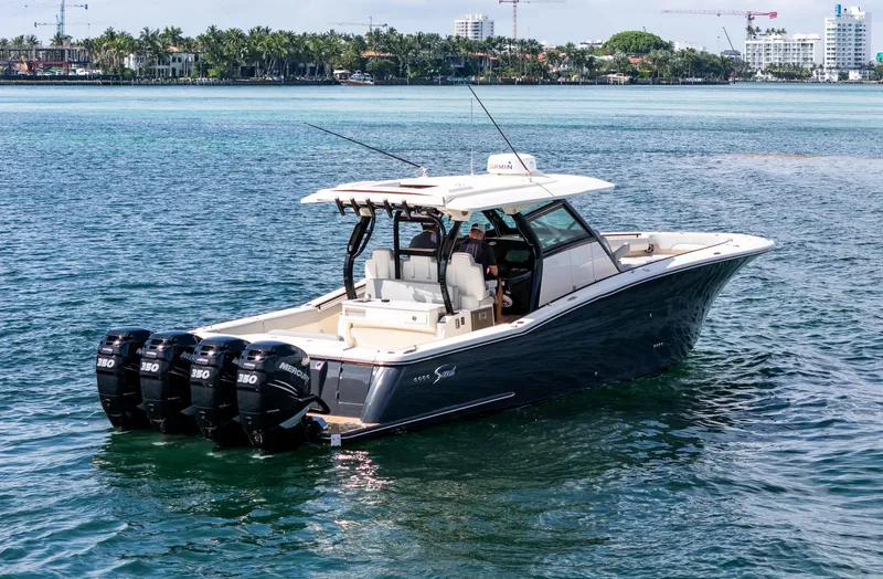  Yacht Photos Pics 2020 Scout 380 LXF boat with four engines cruising on clear blue water.