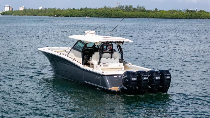  Yacht Photos Pics 2020 Scout 380 LXF boat with four Mercury engines on a calm waterway.