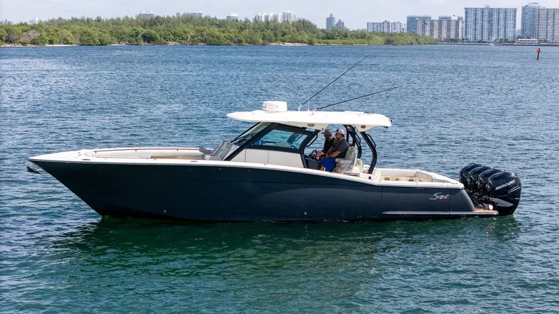  Yacht Photos Pics 2020 Scout 380 LXF boat on water with city skyline in background.