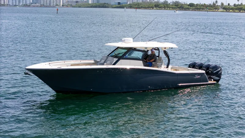  Yacht Photos Pics 2020 Scout 380 LXF boat on water with city skyline in background.