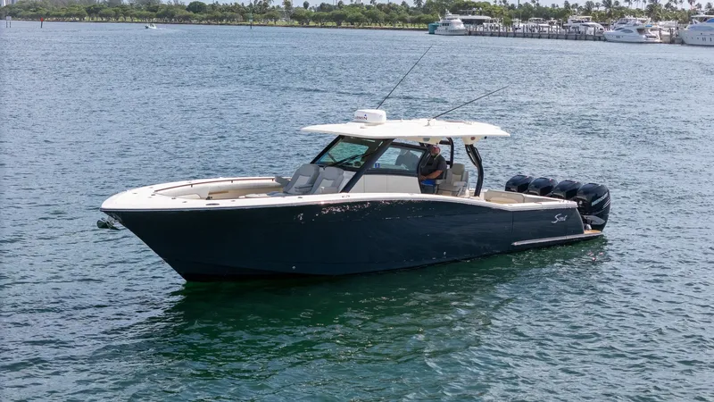  Yacht Photos Pics 2020 Scout 380 LXF boat cruising on a calm, scenic waterway.