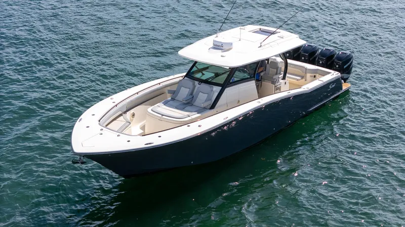  Yacht Photos Pics 2020 Scout 380 LXF boat on water, featuring sleek design and multiple outboard engines.
