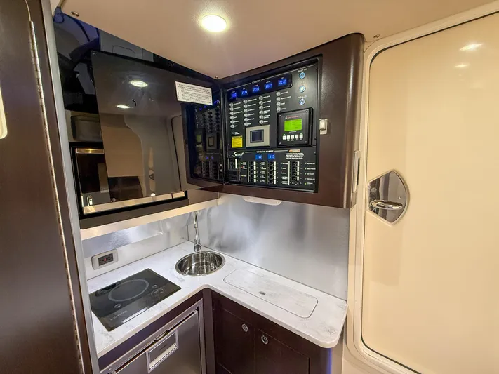  Yacht Photos Pics 2020 Scout 380 LXF yacht interior with control panel, sink, and induction cooktop.
