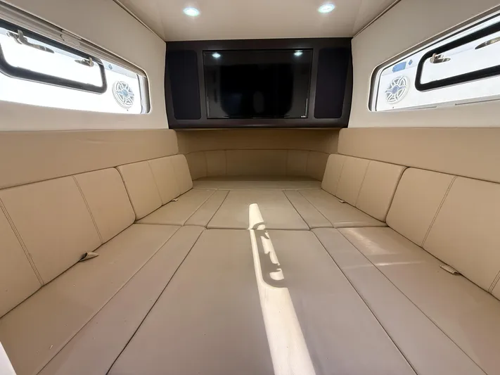  Yacht Photos Pics Luxurious interior cabin of 2020 Scout 380 LXF boat with beige seating and TV.