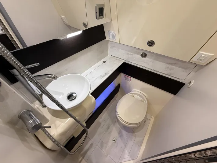  Yacht Photos Pics 2020 Scout 380 LXF boat bathroom with modern sink, toilet, and sleek design.