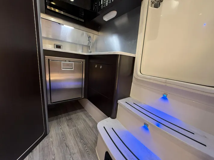  Yacht Photos Pics Interior of 2020 Scout 380 LXF boat with modern kitchen and illuminated steps.