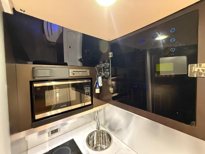  Yacht Photos Pics Modern kitchen area in 2020 Scout 380 LXF boat with microwave and sink.