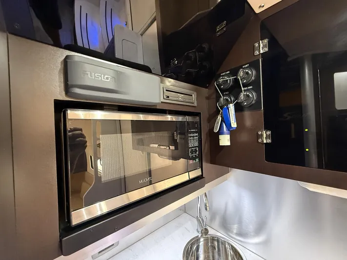  Yacht Photos Pics Interior of 2020 Scout 380 LXF boat featuring microwave and control panel.