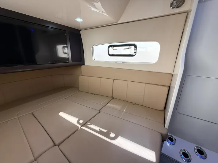  Yacht Photos Pics Interior of 2020 Scout 380 LXF boat with beige seating and a mounted TV.
