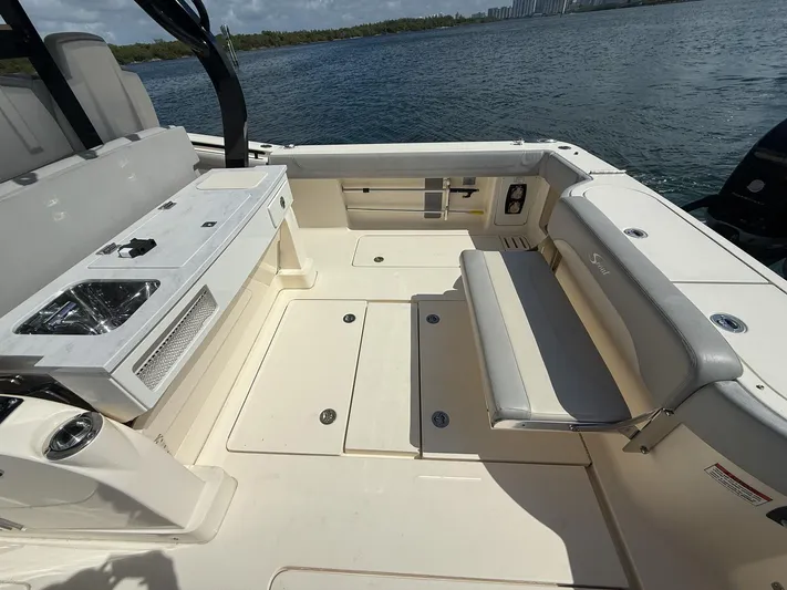 Yacht Photos Pics 2020 Scout 380 LXF boat interior with seating and sink, overlooking water.
