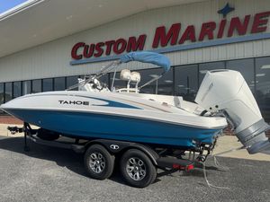 2025 Tahoe 2150 CC boat on trailer at Custom Marine dealership.