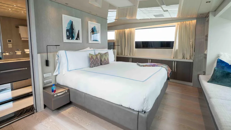 Honey Pot Yacht Photos Pics Luxurious bedroom on the 2019 Sanlorenzo SL 106 yacht with modern decor and large windows.