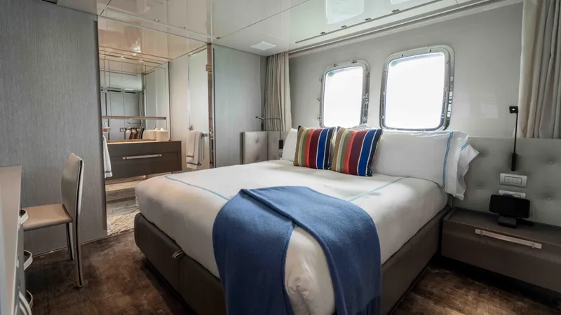 Honey Pot Yacht Photos Pics Luxurious bedroom interior of 2019 Sanlorenzo SL 106 yacht with modern decor and large windows.