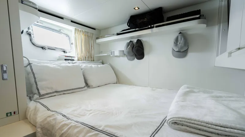 Honey Pot Yacht Photos Pics 2019 Sanlorenzo SL 106 yacht bedroom with white bedding and storage shelves.