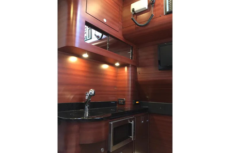  Yacht Photos Pics Luxurious 2017 Mystic Powerboats M4200 interior with sleek wood finish and modern amenities.