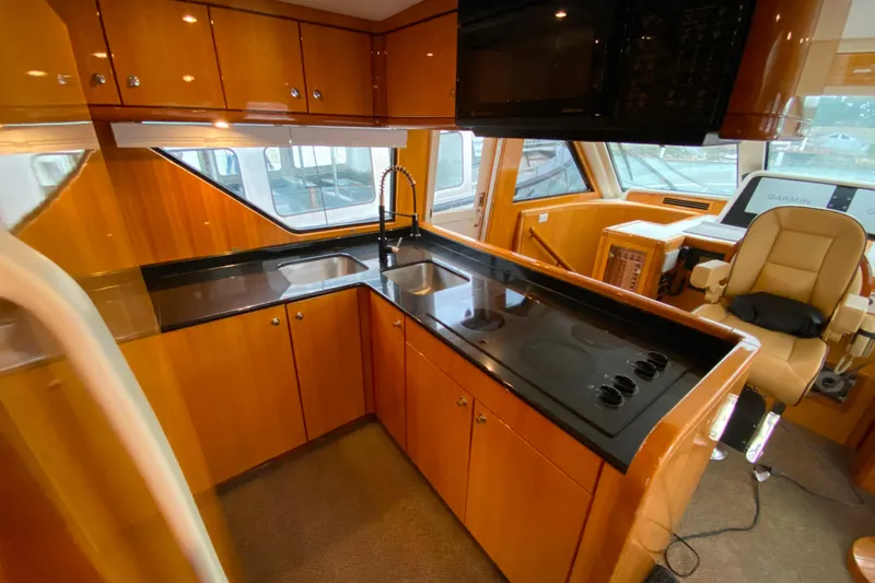  Yacht Photos Pics Luxurious kitchen interior of 2001 Compass 57 yacht with modern appliances and sleek design.