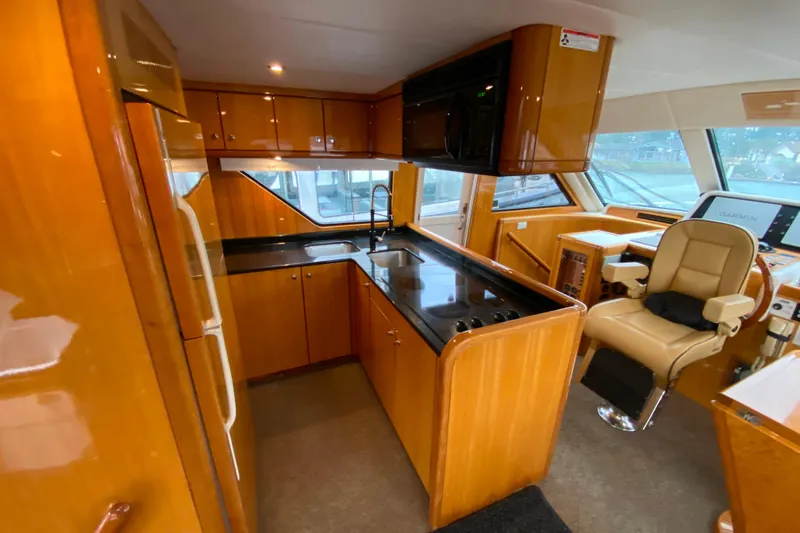  Yacht Photos Pics Luxurious 2001 Compass 57 yacht interior with modern kitchen and navigation area.