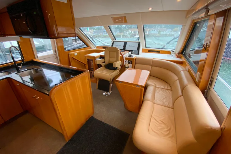  Yacht Photos Pics Luxurious interior of 2001 Compass 57 yacht with leather seating and modern navigation equipment.