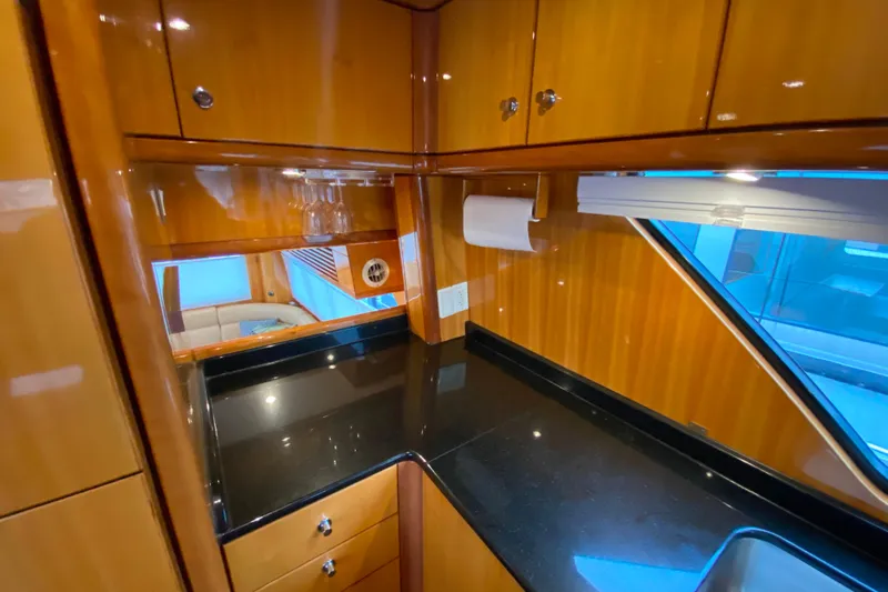  Yacht Photos Pics Luxurious wooden interior of 2001 Compass 57 yacht with sleek black countertop.