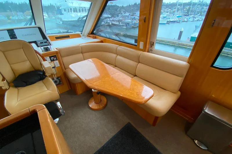  Yacht Photos Pics Luxurious interior of 2001 Compass 57 yacht with leather seating and wooden table.