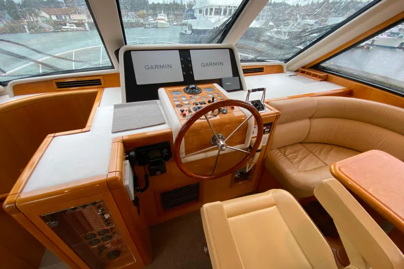  Yacht Photos Pics Luxurious 2001 Compass 57 yacht helm with Garmin navigation and plush seating.