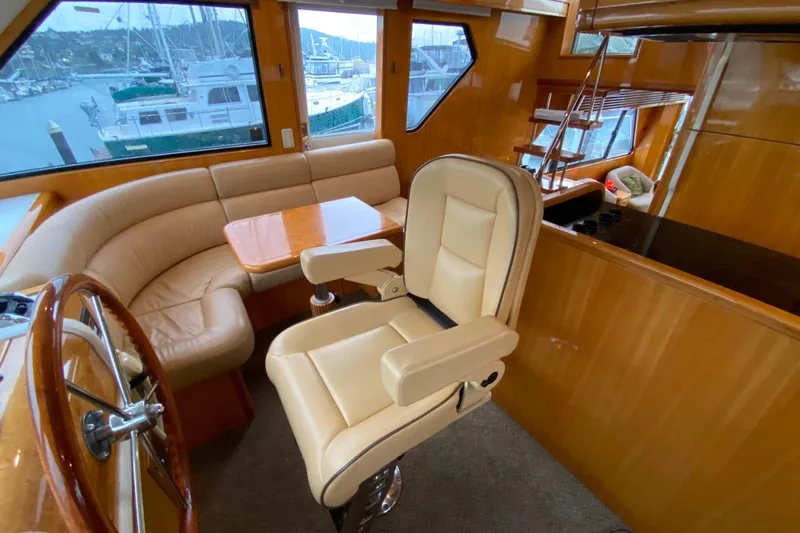 Yacht Photos Pics Luxurious interior of 2001 Compass 57 yacht with leather seating and wooden accents.