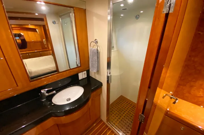  Yacht Photos Pics Luxurious bathroom in 2001 Compass 57 yacht with wooden accents and glass shower.