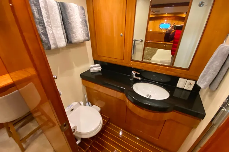  Yacht Photos Pics Luxurious bathroom in 2001 Compass 57 yacht with wooden cabinetry and modern fixtures.