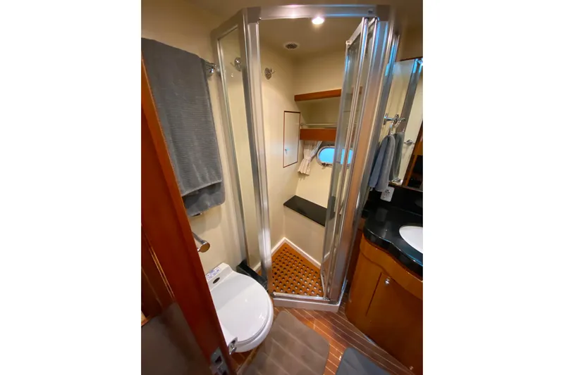  Yacht Photos Pics Compact bathroom in 2001 Compass 57 yacht with shower, toilet, and sink.