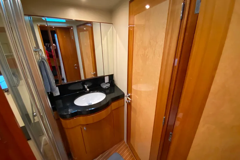  Yacht Photos Pics Luxurious bathroom in 2001 Compass 57 yacht with wooden cabinetry and modern fixtures.