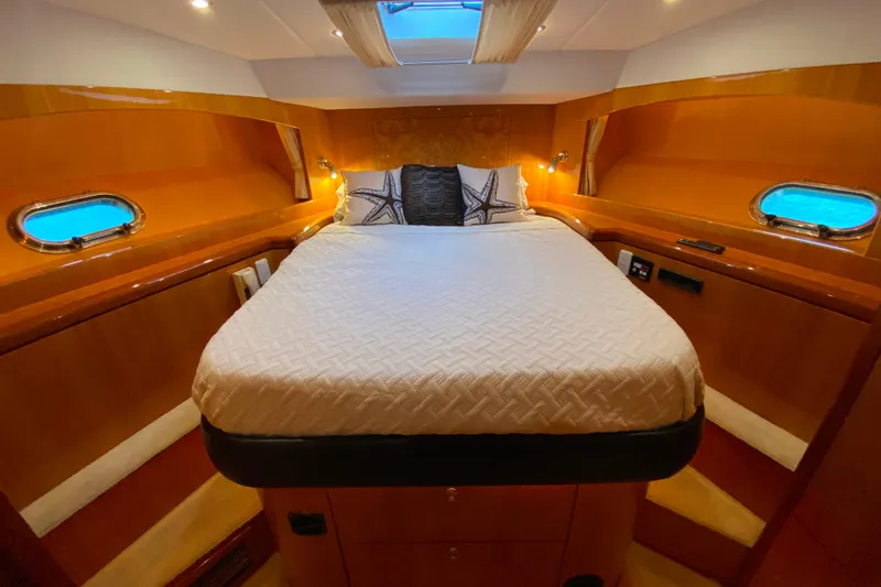  Yacht Photos Pics Luxurious cabin interior of 2001 Compass 57 yacht with cozy bed and porthole windows.