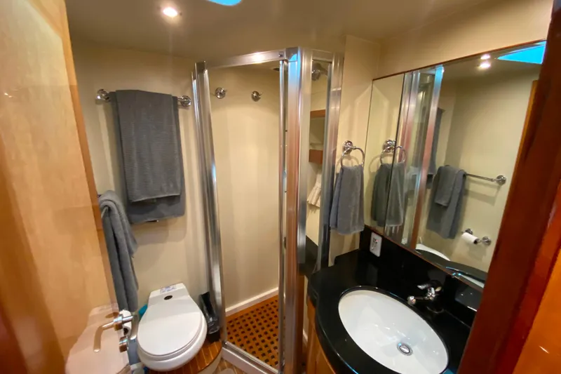  Yacht Photos Pics Luxurious bathroom in 2001 Compass 57 yacht with modern fixtures and elegant design.