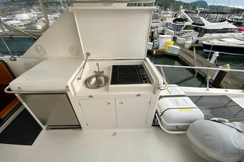  Yacht Photos Pics Outdoor kitchen on a 2001 Compass 57 yacht with sink and grill at marina.