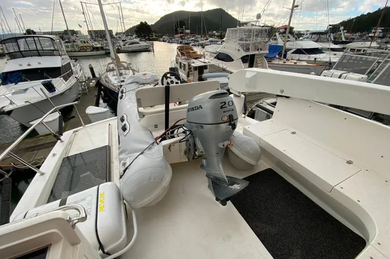  Yacht Photos Pics Compass 57 boat, 2001 model, with Honda outboard motor, docked at marina.