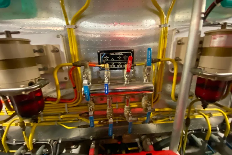  Yacht Photos Pics Engine room of 2001 Compass 57 yacht with complex piping and valves.