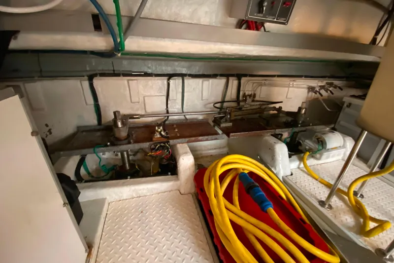  Yacht Photos Pics Engine room of a 2001 Compass 57 boat with mechanical components and yellow hose.