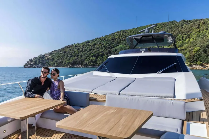  Yacht Photos Pics Couple relaxing on 2019 Ferretti Yachts 920, scenic ocean view in background.