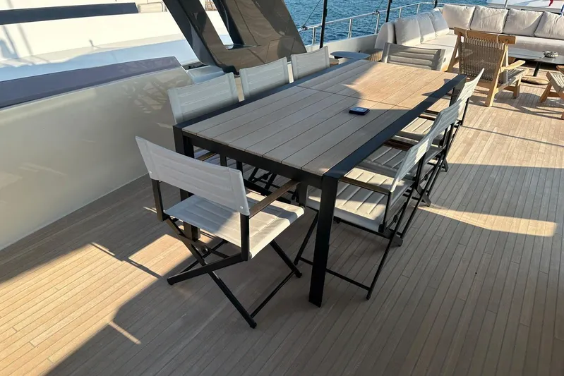  Yacht Photos Pics Outdoor dining area on 2019 Ferretti Yachts 920, featuring modern table and chairs.