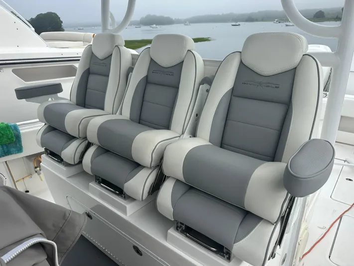 Fly Girl Yacht Photos Pics 2020 Invincible 39 Open Fisherman boat seats, gray and white, with scenic water view.